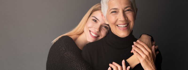 Studio shot of mother and daughter. Both of them wearing black.